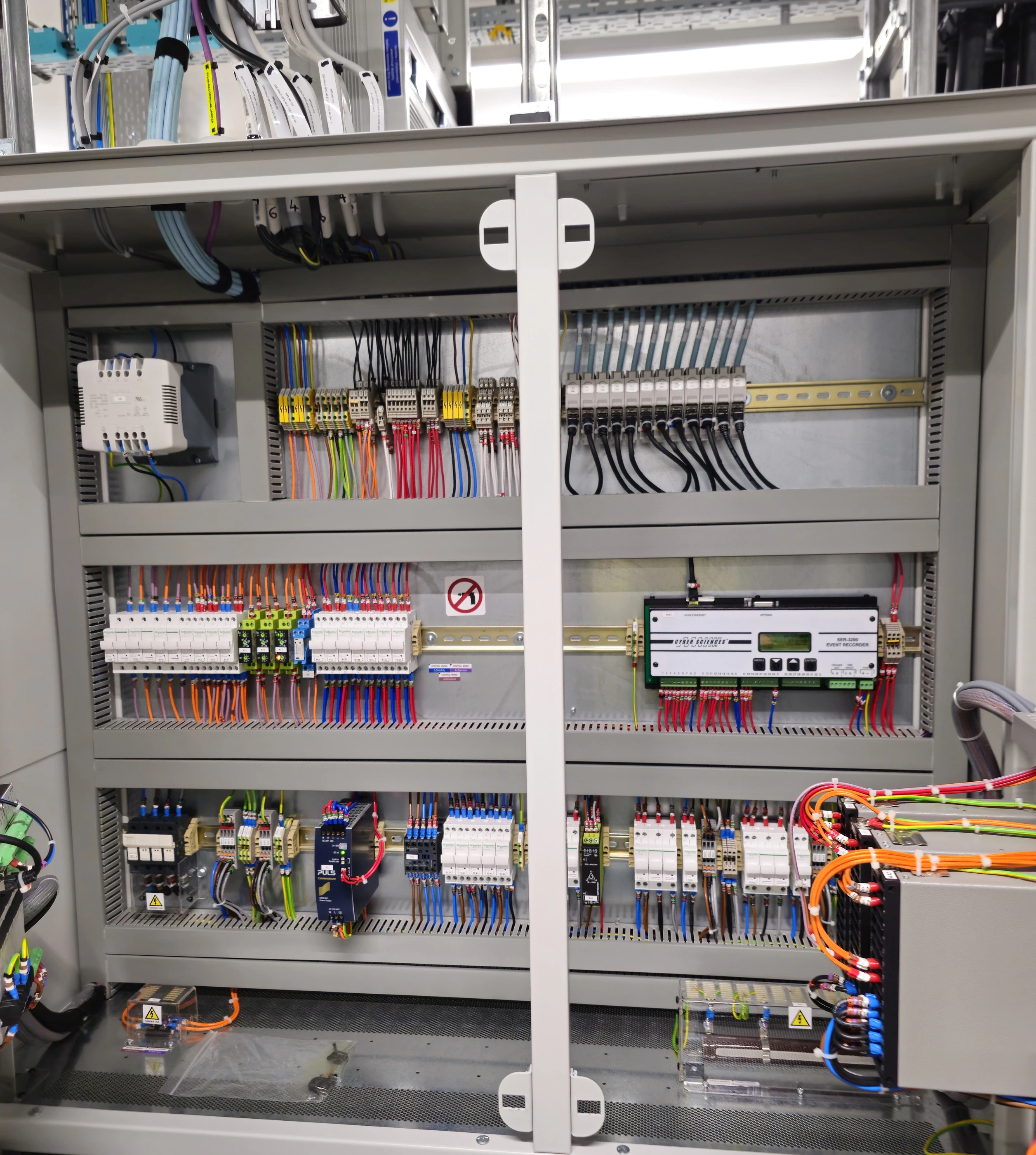 Interior of a control cabinet with terminal blocks, wiring, control components and cable ducts. Interior of a control cabinet with terminal blocks, wiring, control components and cable ducts.
