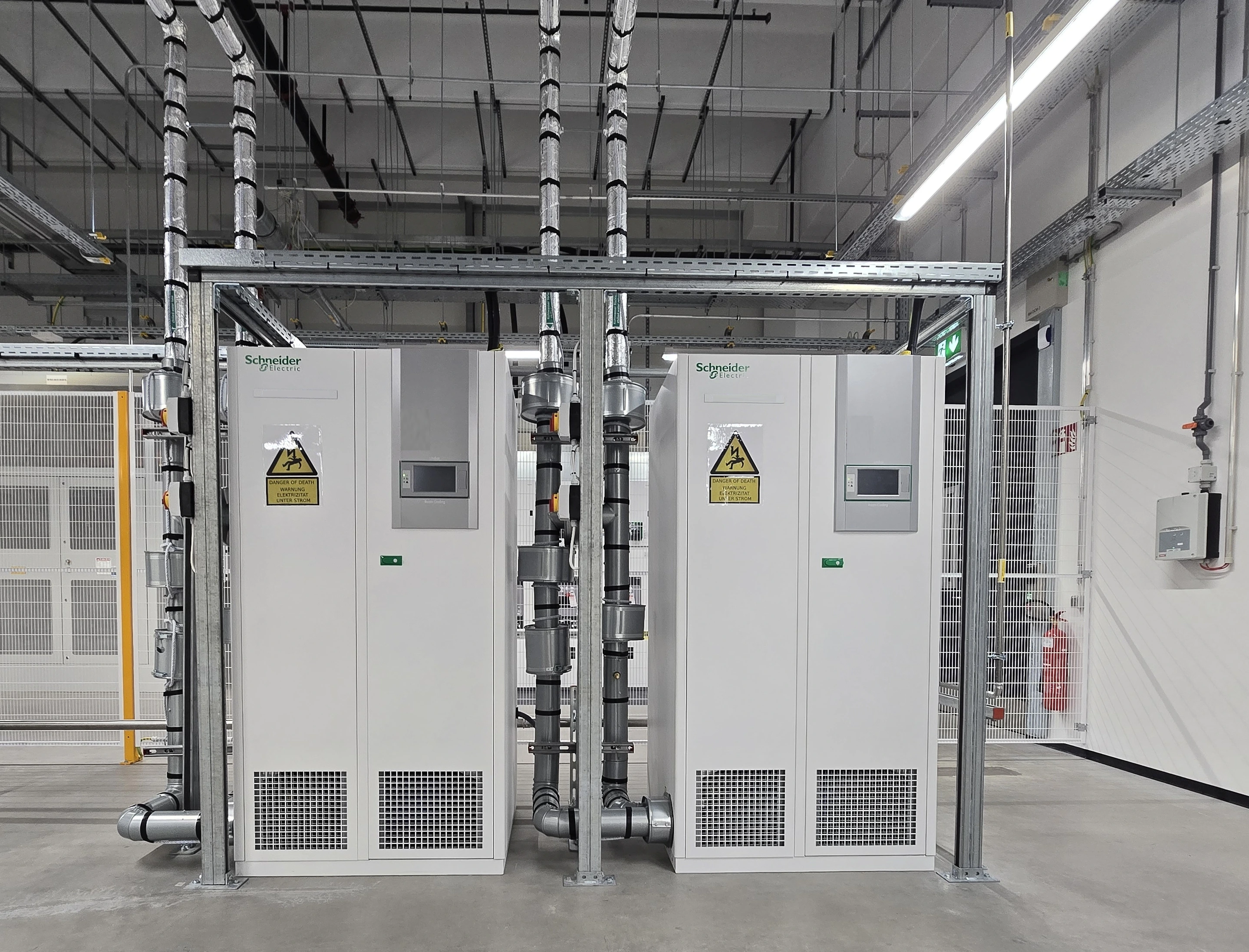 CRAH units with connected pipework and overhead cable trays CRAH units with connected pipework and overhead cable trays