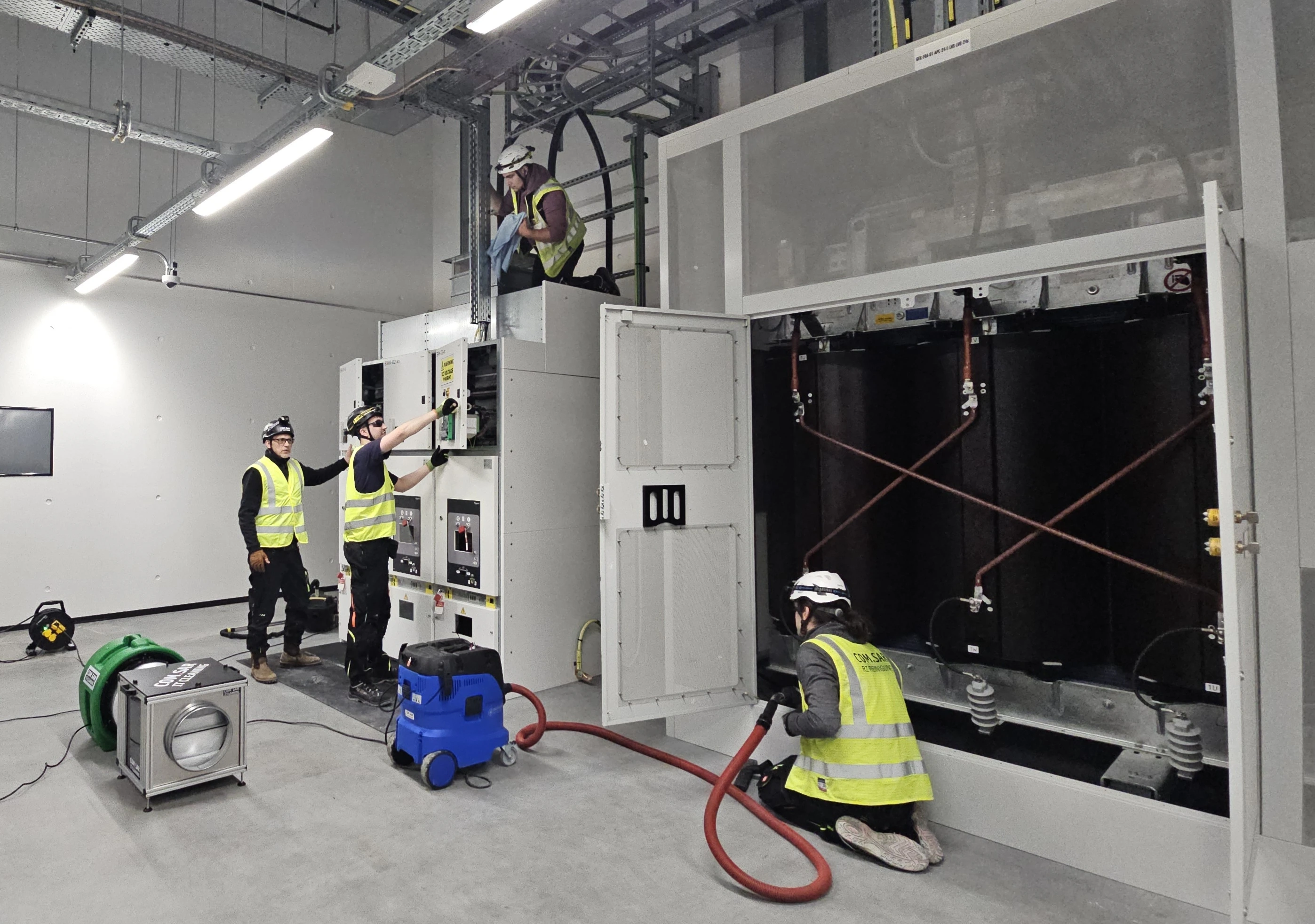 COM.SAR IT Cleaning team members cleaning a transformer, switchgear, enclosure surfaces and surrounding areas. COM.SAR IT Cleaning team members cleaning a transformer, switchgear, enclosure surfaces and surrounding areas.