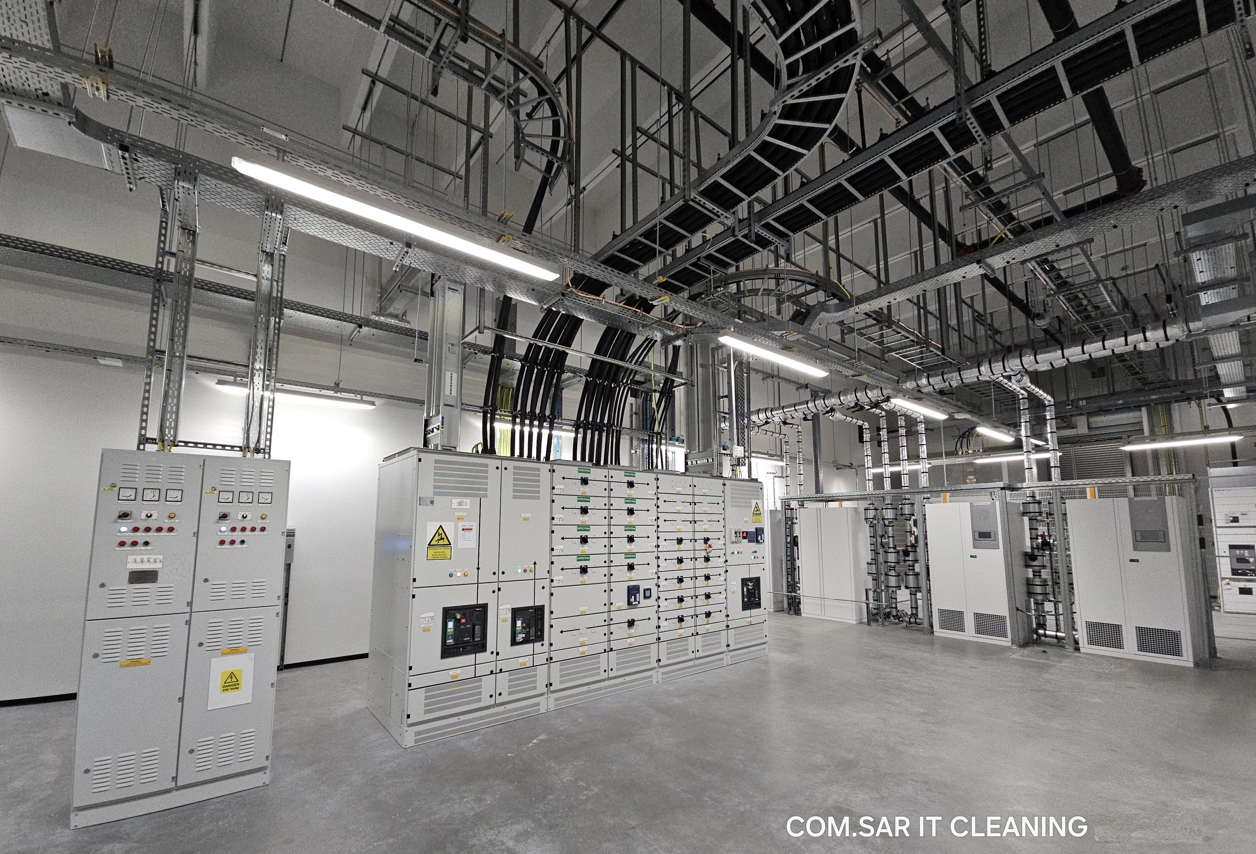 Technical room with switchgear, cooling equipment, pipework and cable trays Technical room with switchgear, cooling equipment, pipework and cable trays